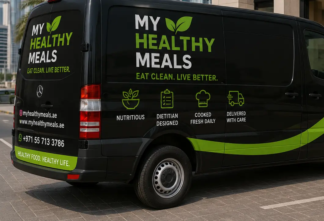 A MyHealthyMeals delivery van on a Dubai street, marked with the website address and WhatsApp number